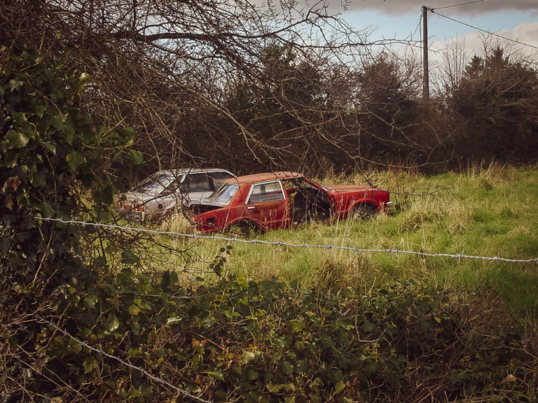 Cars dumped in a field