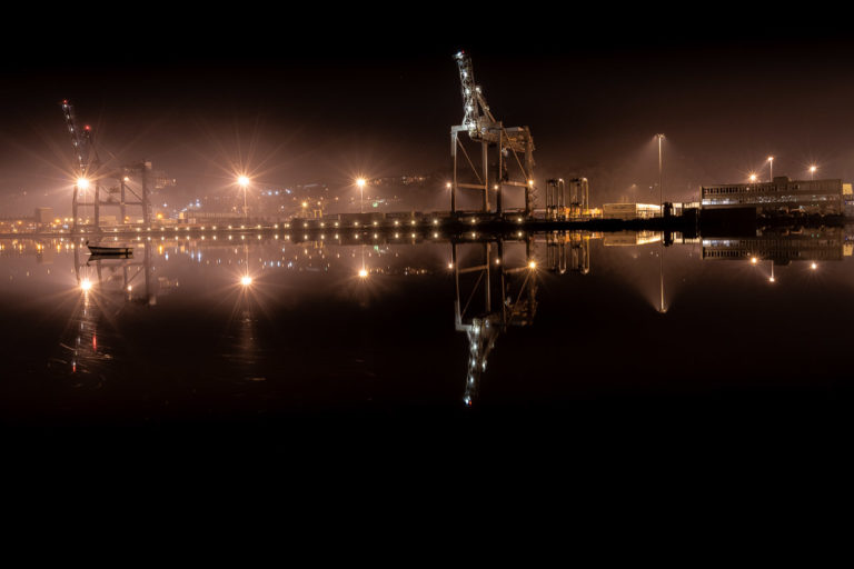 A night shot of the docklands at Tivoli on the RIver Lee where cranes lift containers on ships for transport in and out of the country.