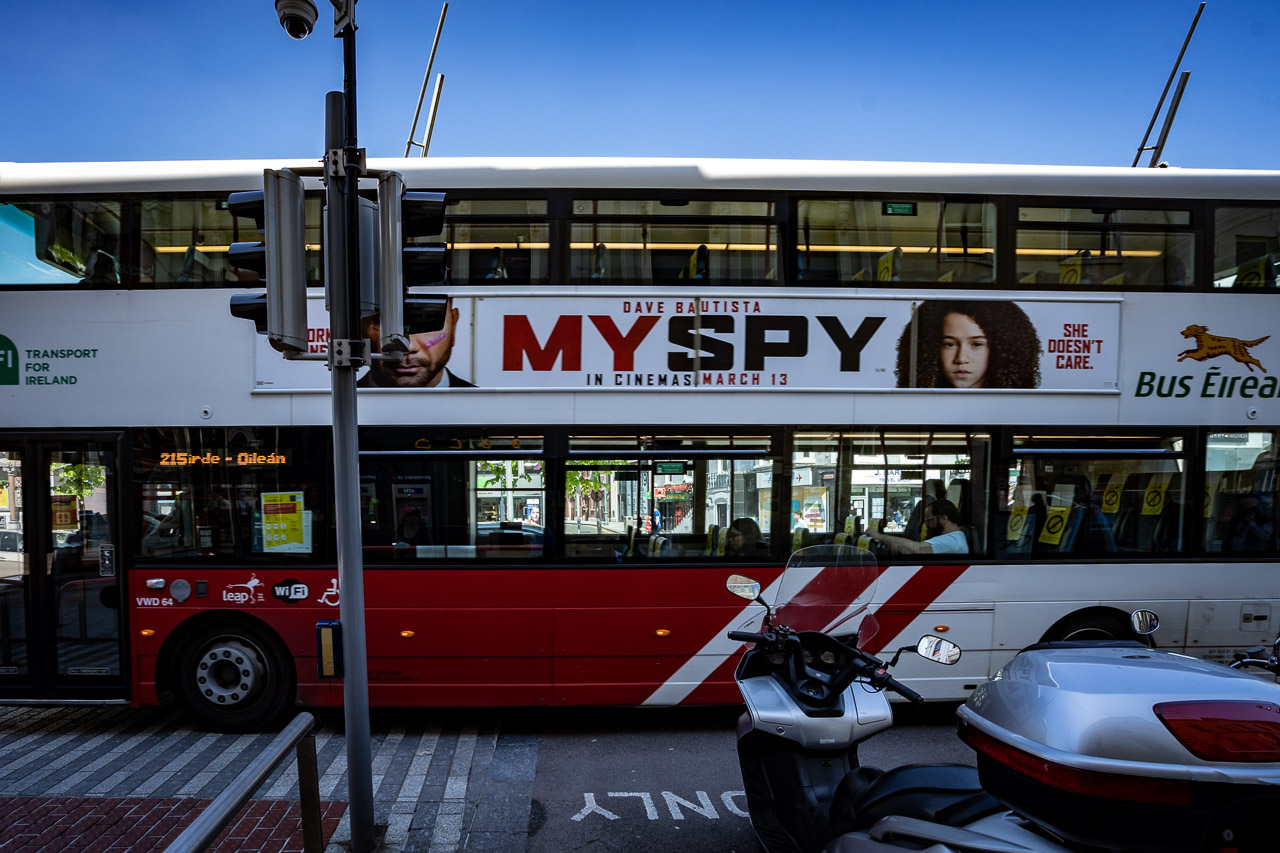 A double decker bus with a couple of masked passengers on it and an advert for the movie, My Spy, which was due to be in cinemas on March 13th.