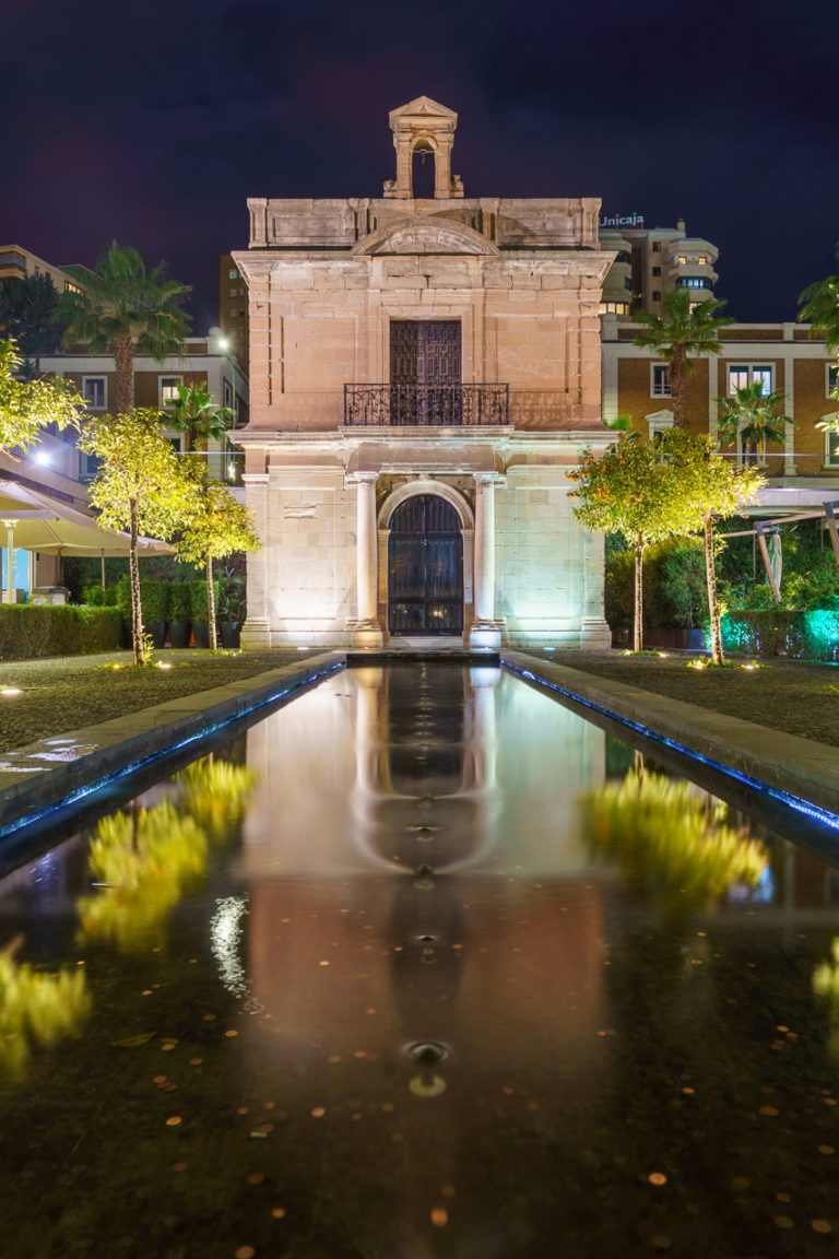A small church at one end of a shallow pool.