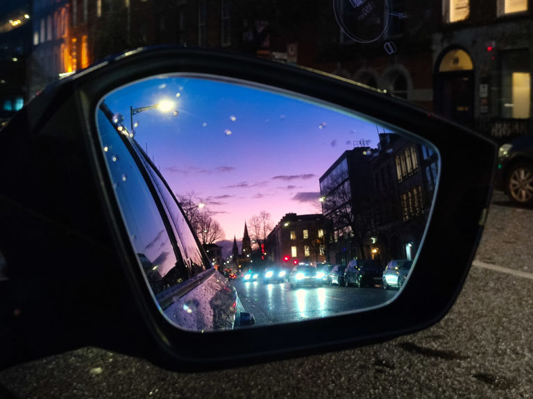 A purple sky seen in the side mirror of my car