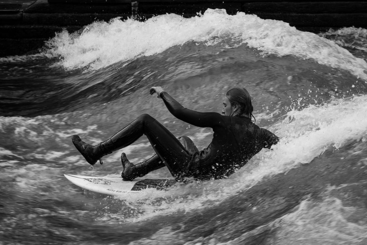 A surfer on the River Isar sits on his surfboard