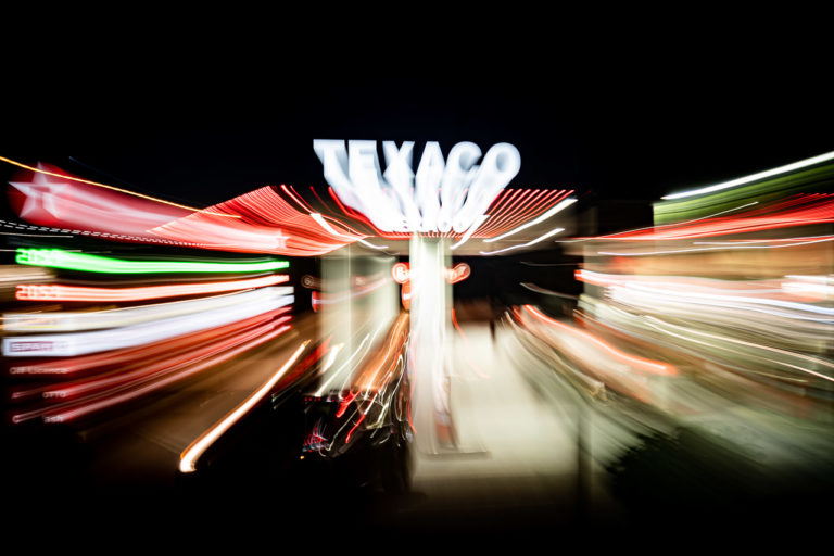A long exposure shot of the Texaco petrol station in Dingle. I zoomed in (or out, I don't recall) while taking the photo so the lights of the signs appear to jump out. Visible are the prices, €2.05 for a litre of petrol or diesel.
