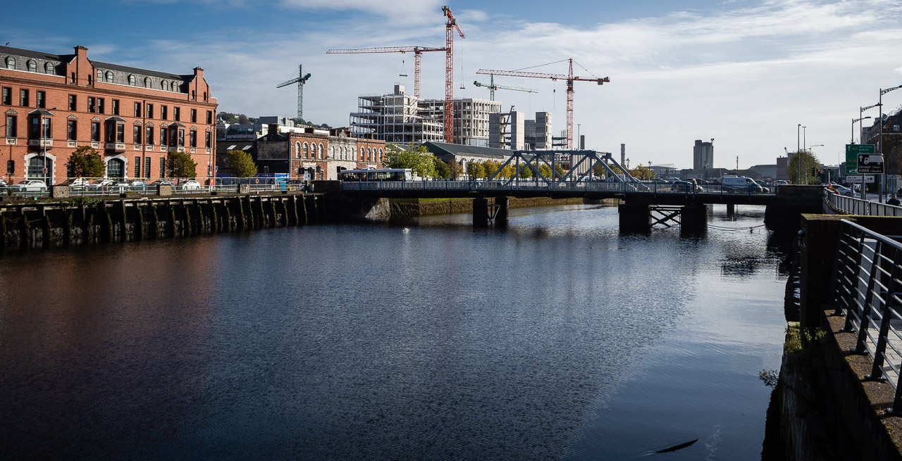 Construction Cranes were on site among the new buildings of Horgan's Quay in Cork. The River Lee is flowing in the foreground, crossed by Brian Boru Bridge nearby.