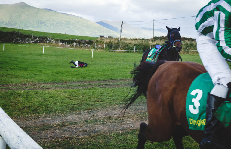 A rider rolls on the ground after coming off his horse at the Dingle Races last year. Another horse and rider and the fallen rider's horse continue running