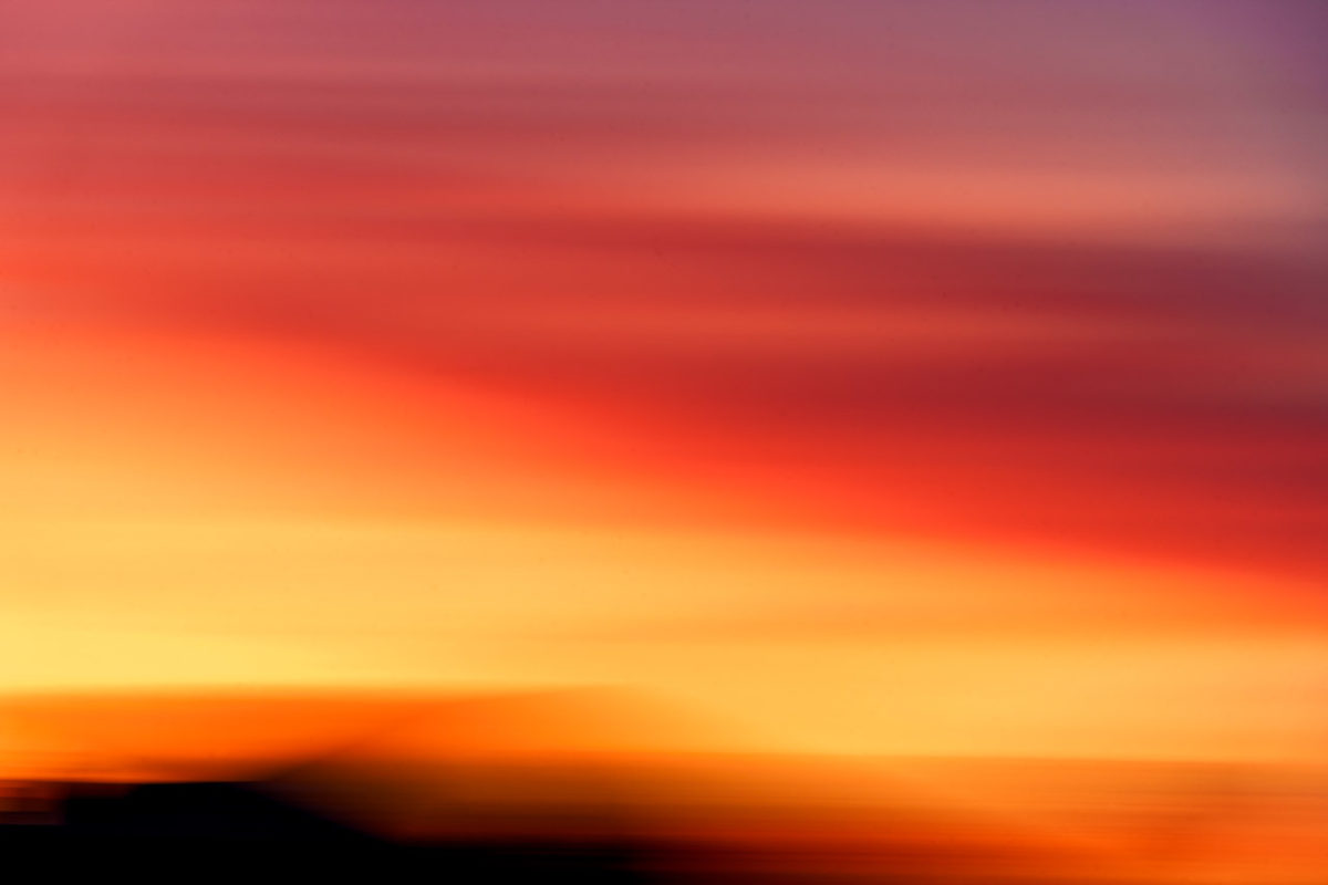An ICM of the setting sun with red, orange, yellow, black and hints of purple.