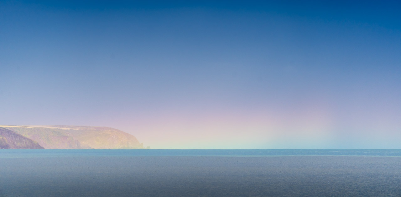 A horizontal rainbow or circumhorizontal arc seen on the horizon over the sea.