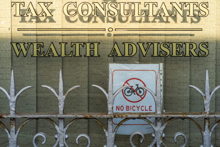 In the window of a tax consultants office, who say they are "wealth advisers", there's a sign saying "No bicycle". The word "parking" is intentionally left out.