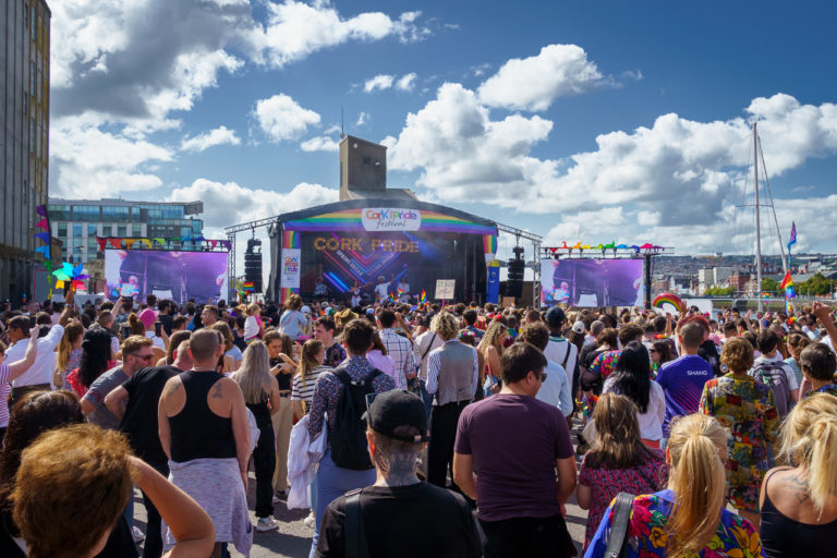 A large crowd gathered to enjoy the after-parade party at Cork Pride 2023. A stage can be seen in the background.
