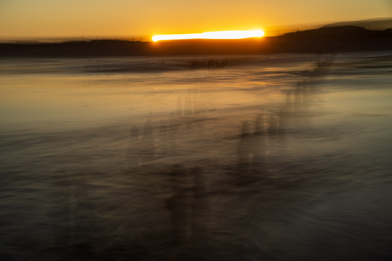 An ICM shot of the setting sun. The lens was swung horizontally meaning the sun left a trail on the horizon and the groynes in the sea are like transparent shadows