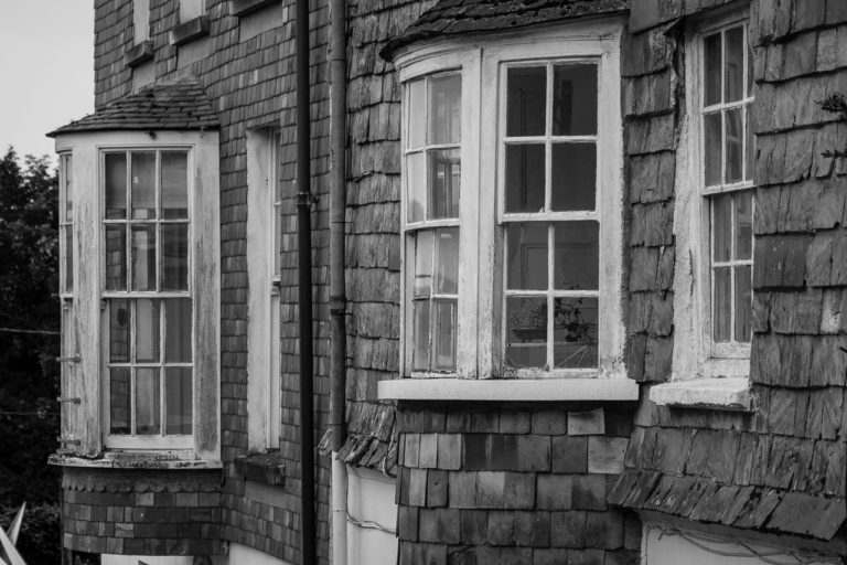 Vertical tiling or tile hanging is a method of putting tiles on a wall. Here are two windows with tiles on the walls surrounding them.