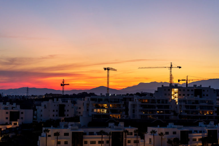 Cranes loom over apartments and hotels near Malaga as the sun sets on a lovely October evening