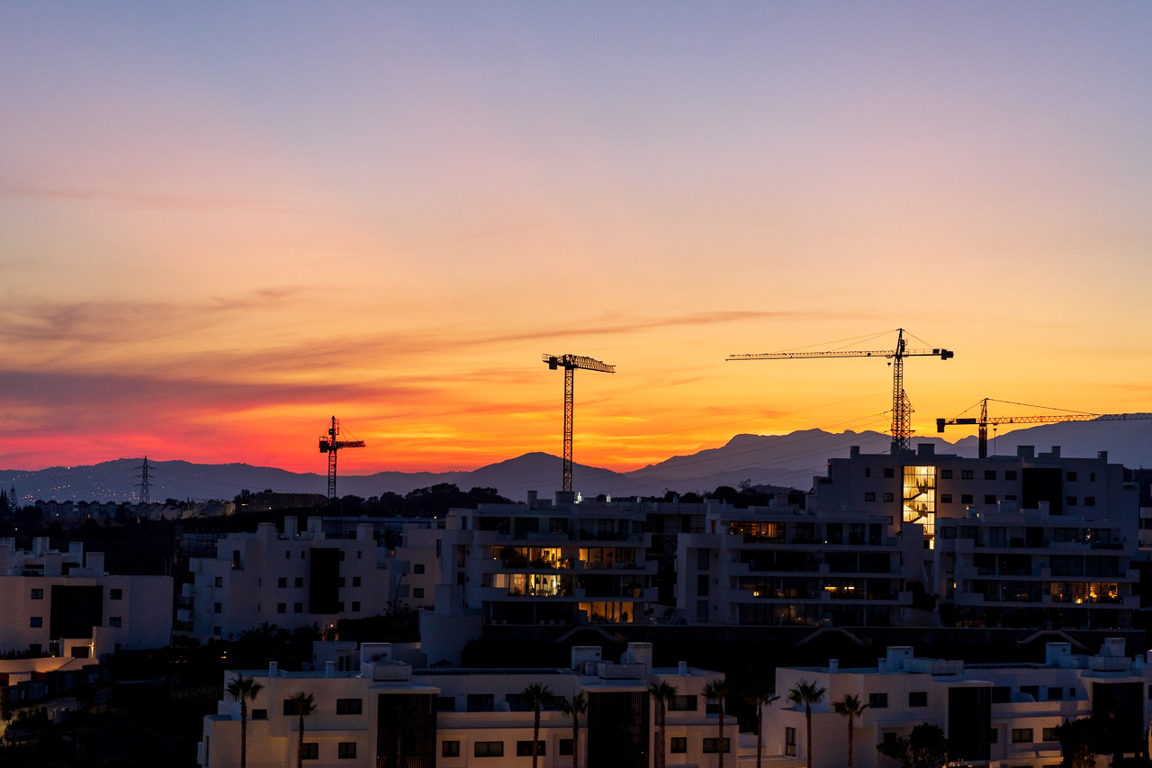 Cranes loom over apartments and hotels near Malaga as the sun sets on a lovely October evening