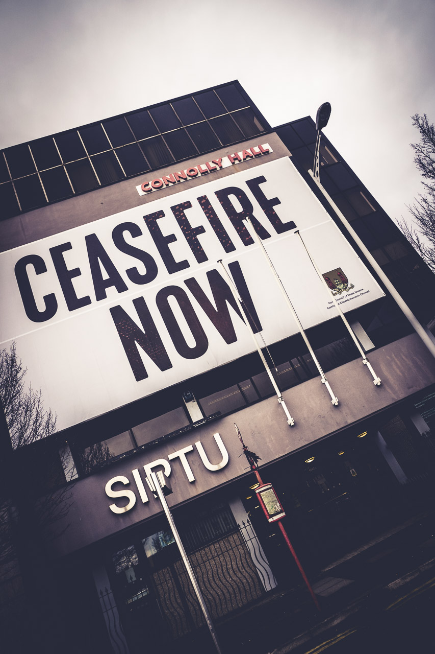 A huge CEASEFIRE NOW poster on the front of Connolly Hall in Cork.