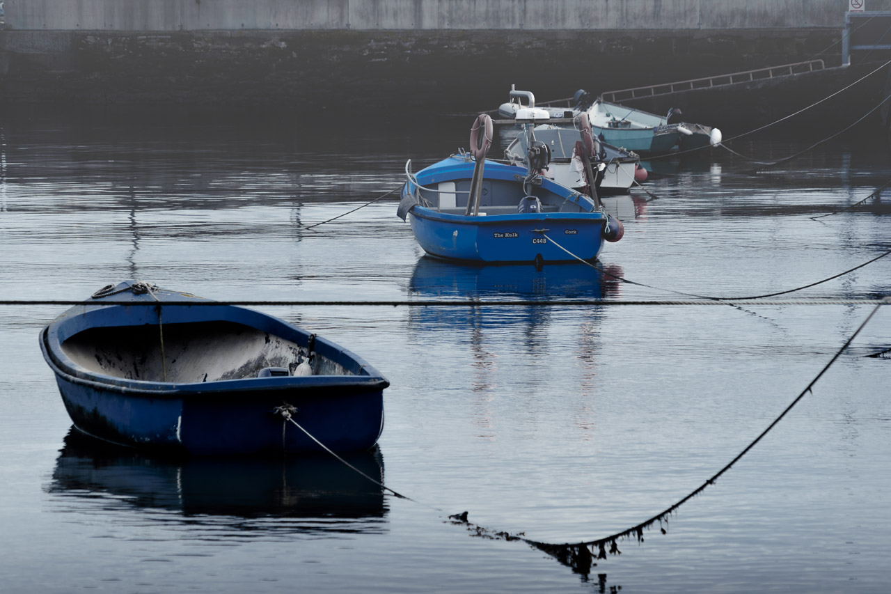 Five boats tied to the quay in Youghal on a dull, misty afternoon.