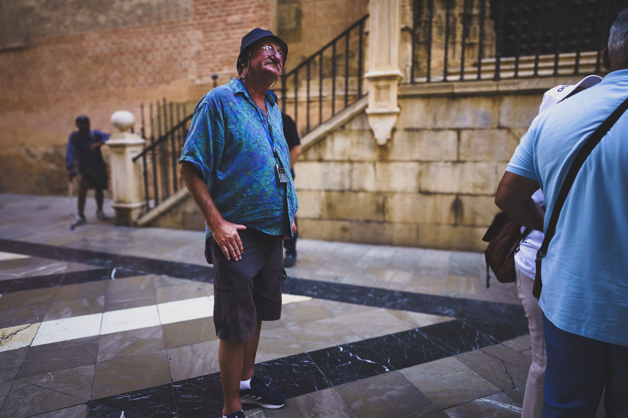 A tourist looks up at something unseen out of frame in Malaga, Spain.