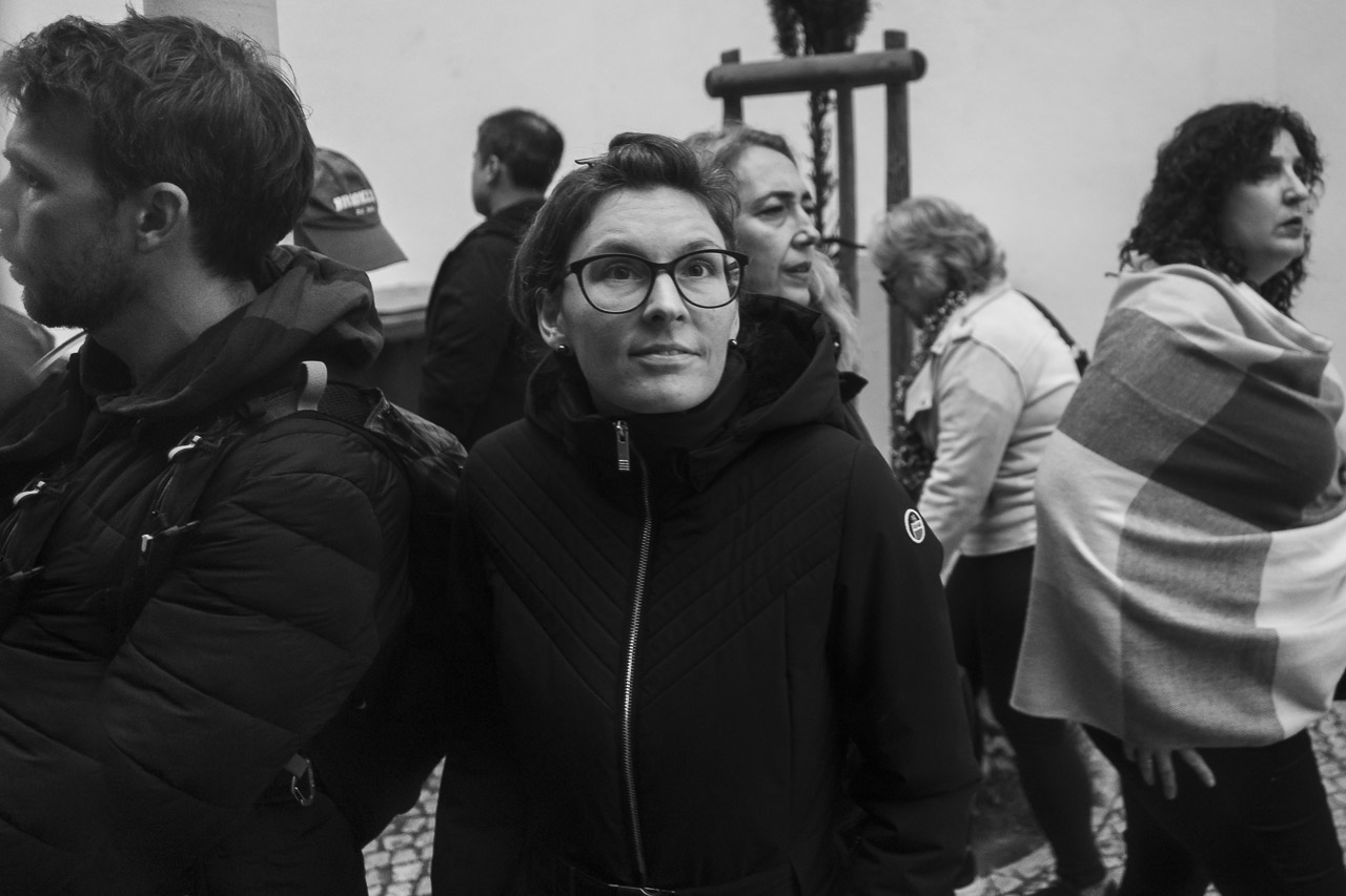 A woman stares at the tram I'm travelling on, unaware that I'm taking her photo. She is dressed warmly as it is November, and even in Lisbon it gets chilly.