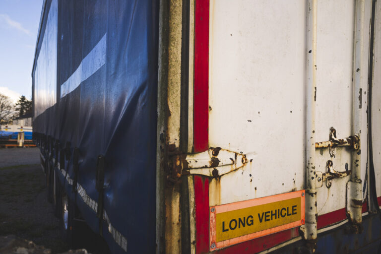 The trailer of a lorry sits in the yard where Piper's Funfair lives in Crosshaven. It has a warning sign on the back saying, "LONG VEHICLE"