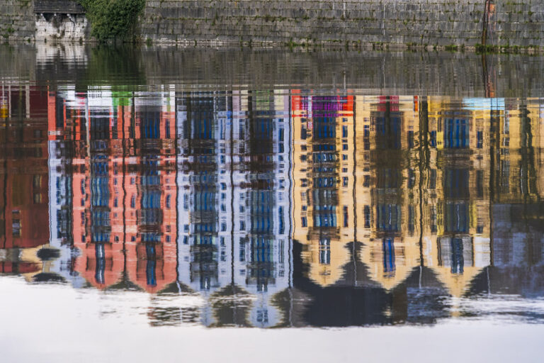 The colourful buildings of Pope's Quay in Cork are reflected in the water of the River Lee.