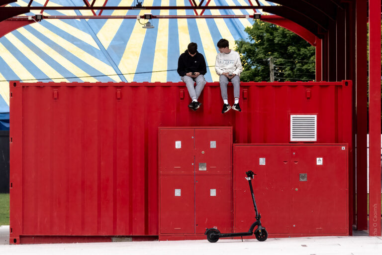 Sitting on a red container