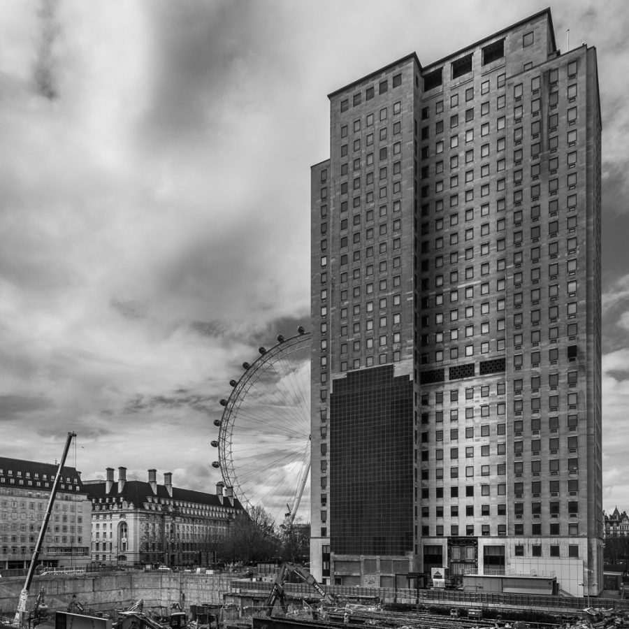 The London Eye as seen from a nearby street, with a building site in between.