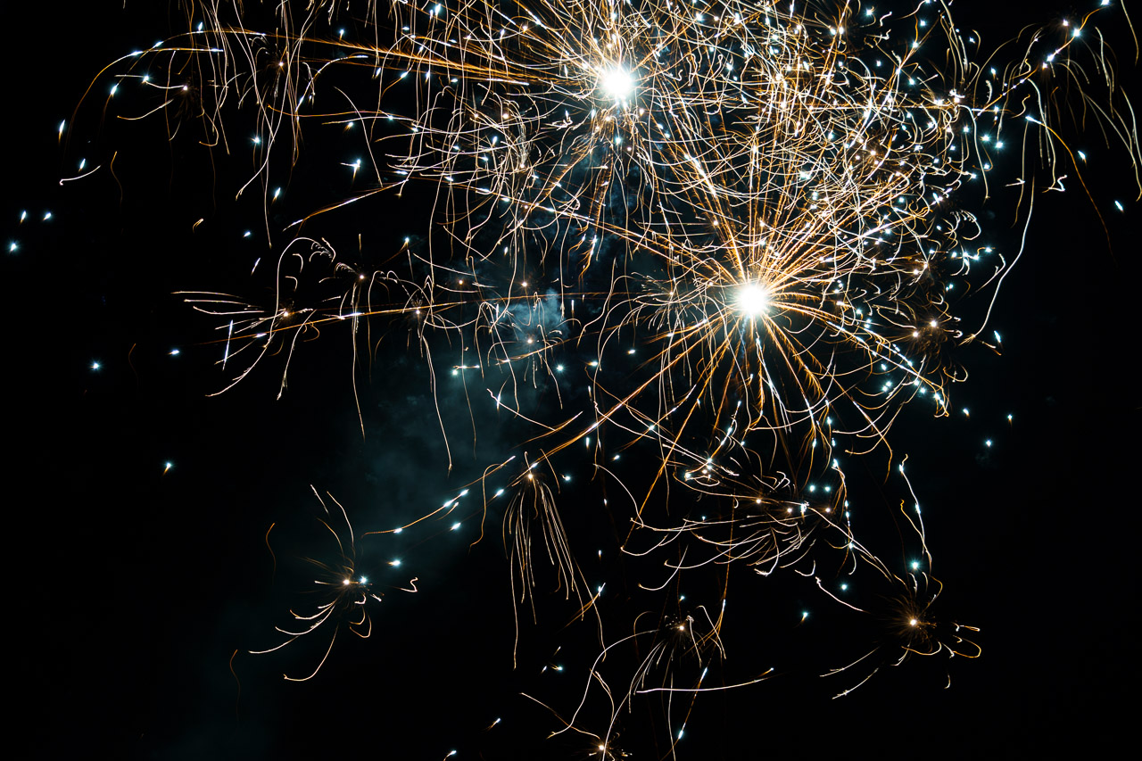 Bright fireworks burst in the sky in an explosion of colour