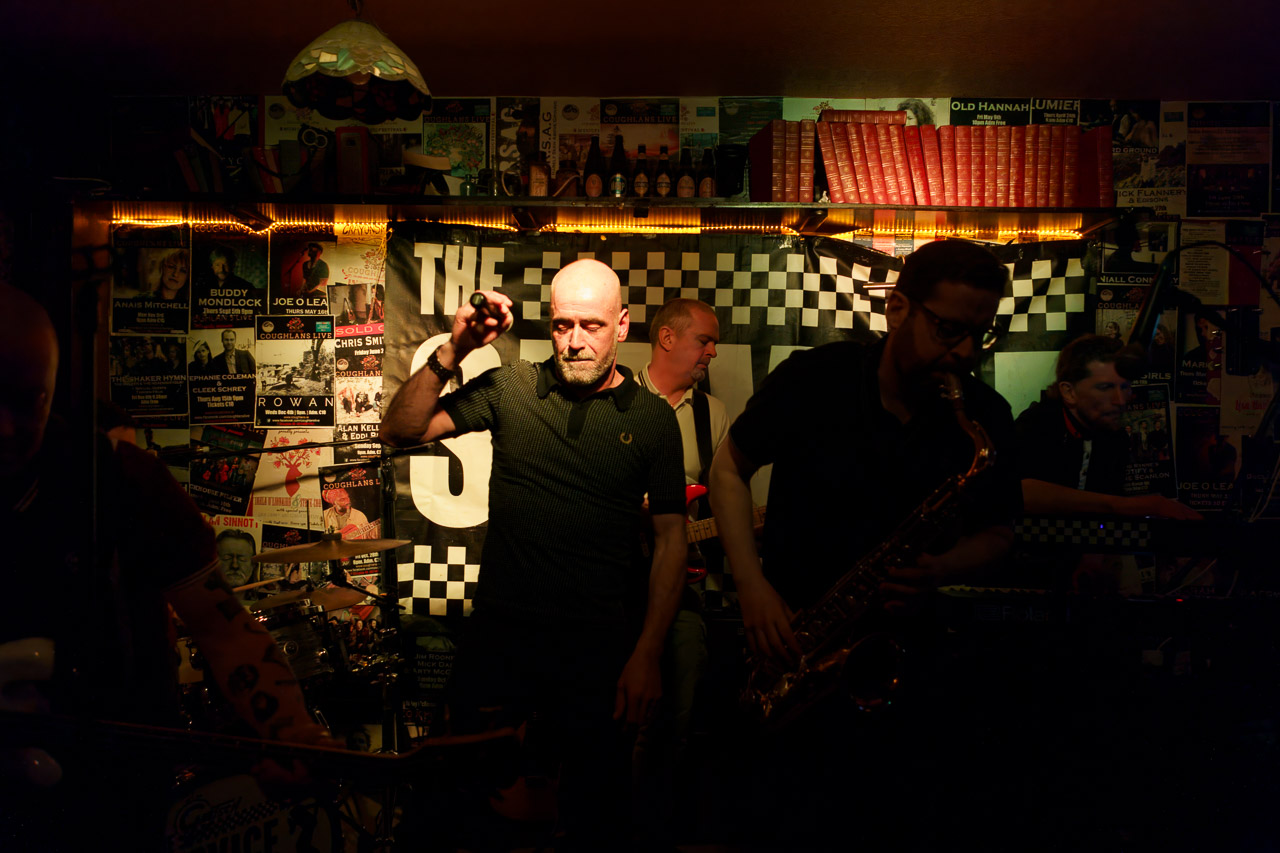 Members of the band, "The Service" performing on stage in Coughlans Bar.