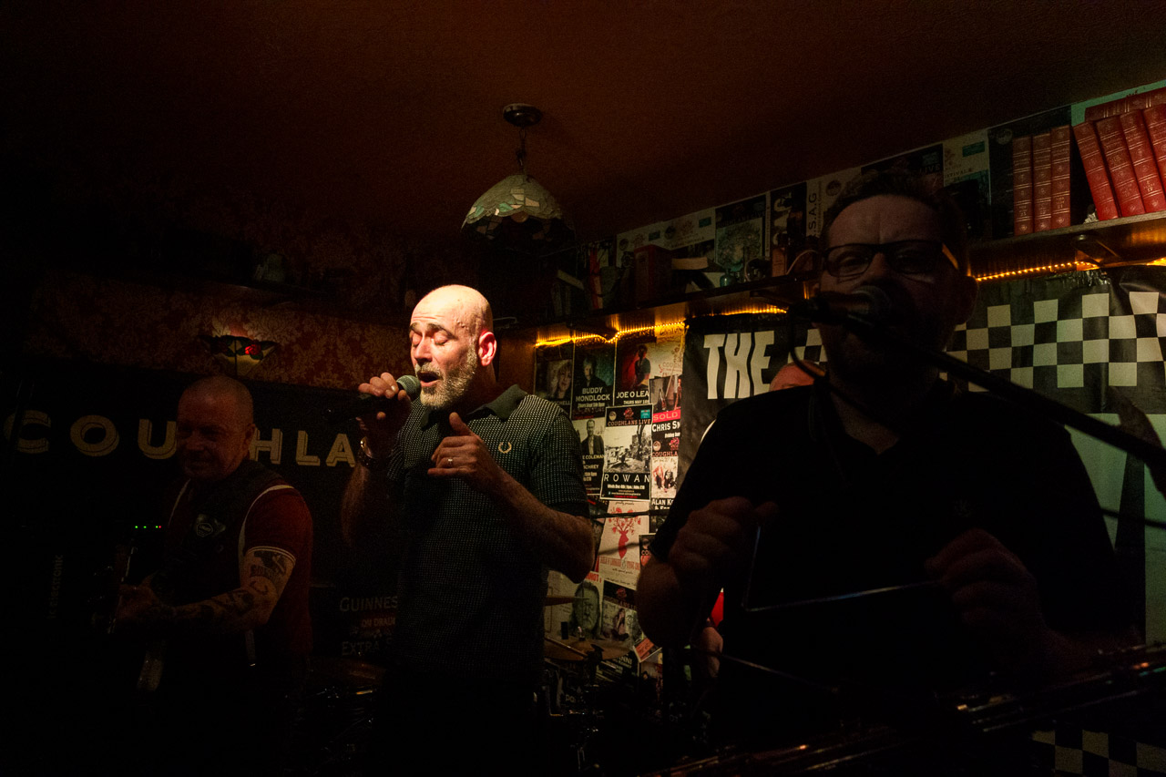Members of the band, "The Service" performing on stage in Coughlans Bar.