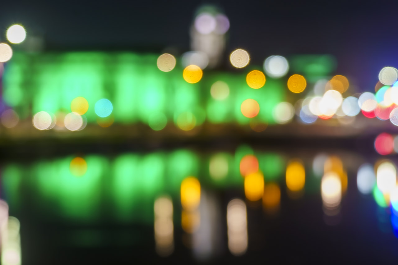 The colours of Cork City Hall and surrounding lights are captured in an out of focus image.
The colours are reflected in the River Lee.