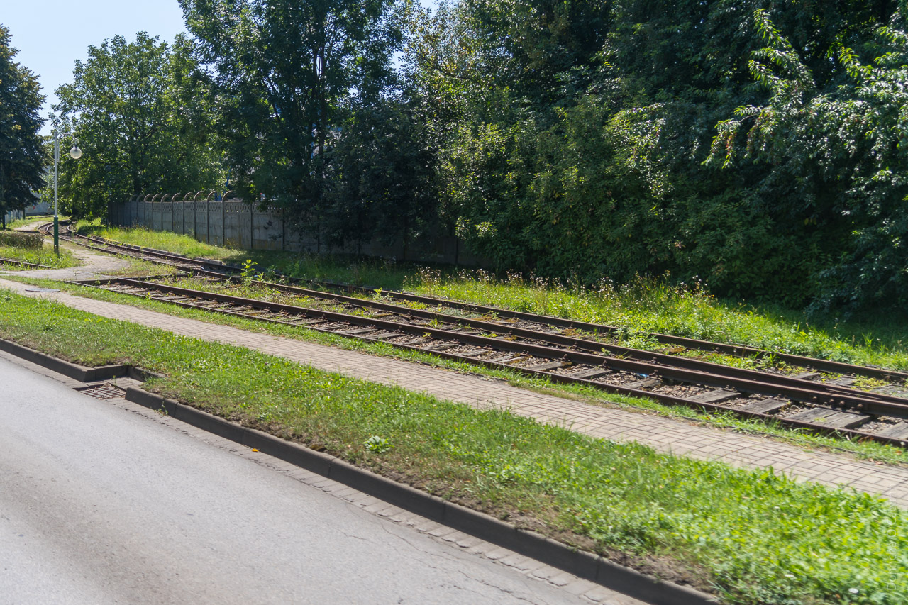 Train tracks running alongside a public road between Auschwitz and Birkenau.