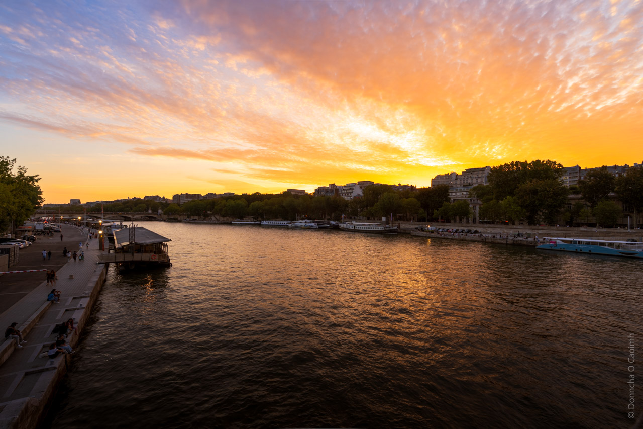 The sun setting on the Seine on a beautiful August evening last year. The sky was a vibrant yellow for a minute or two and reflected off the river below.