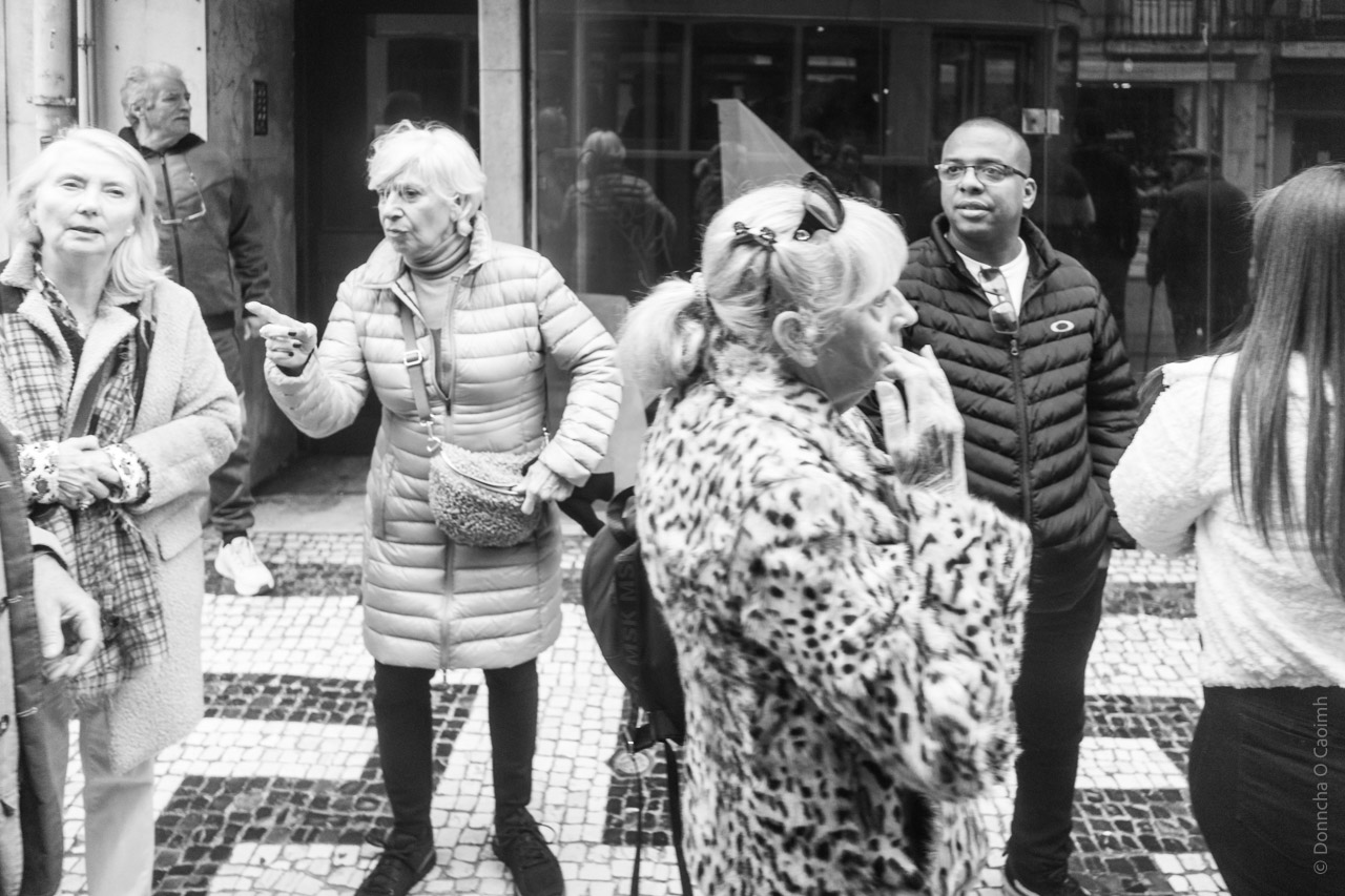 People look on and waiting from the tram on a Lisbon street