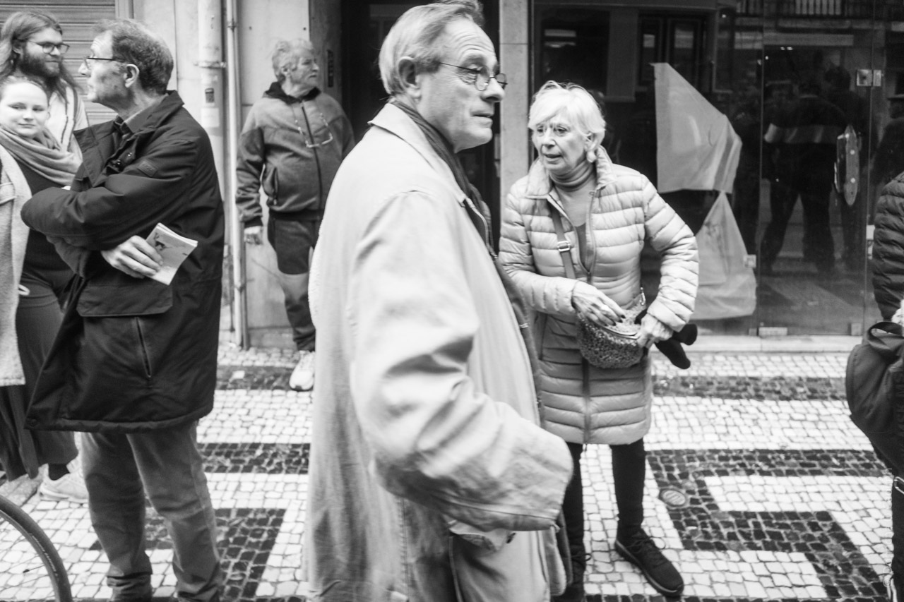 People look on and waiting from the tram on a Lisbon street