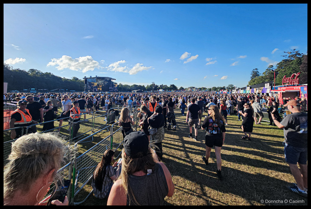 A huge crowd at Marley Park, with the stage visible on the left, stalls on the right and blue skies overhead.
